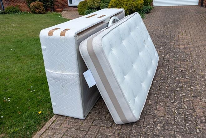 household items being collected for disposal, including a mattress